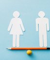 The image shows a man and a woman in paper cut-out standing at each end of a pencil that serves as a seesaw. The seesaw is balanced.